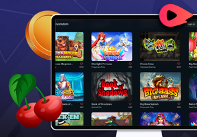 A computer screen shows a casino game selection with a cherry and a coin in the foreground.